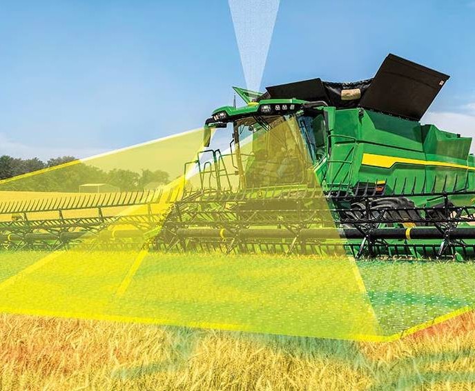 A modern combine harvester in a golden wheat field